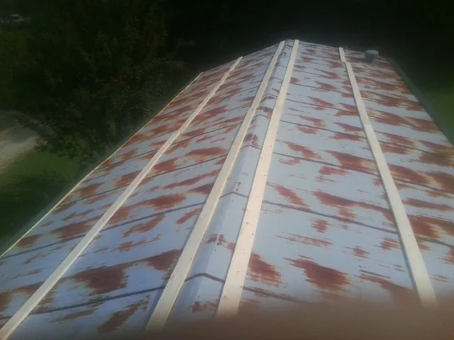 Rusted metal roof panels with new wood purlins before replacement — Storm Damage Roof Repair in Mount Hamilton by Roofing Brothers