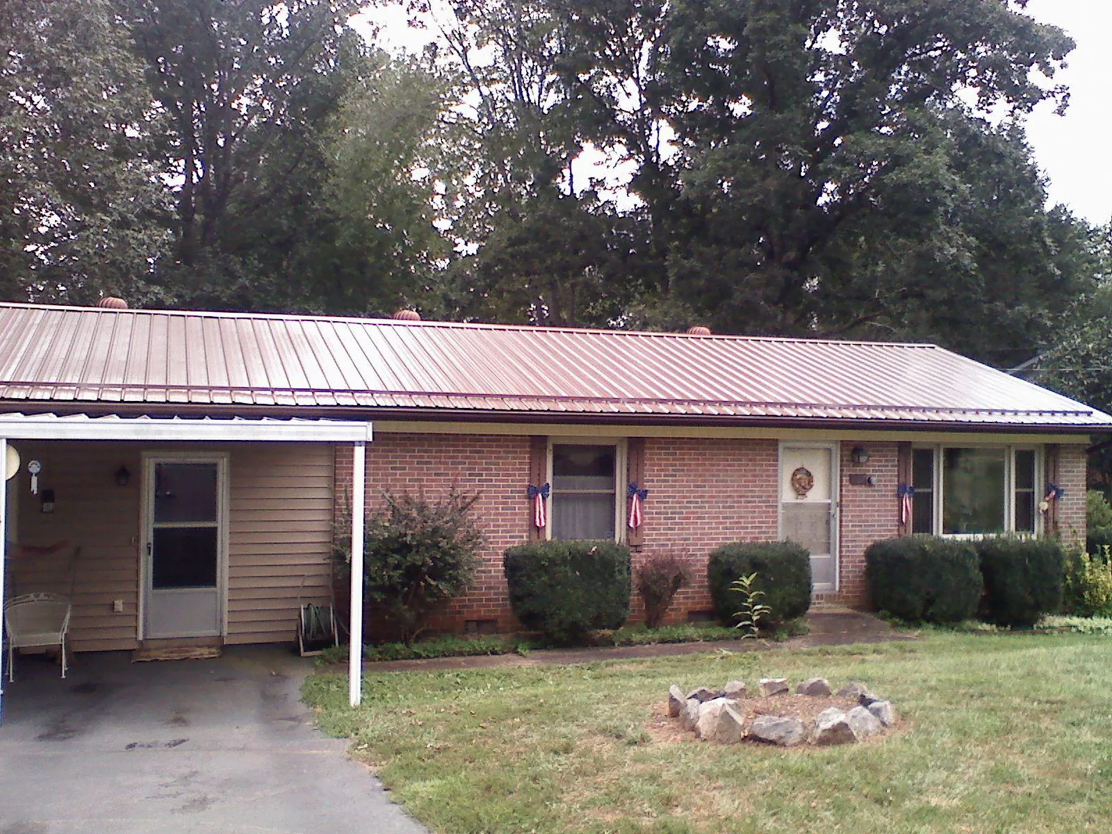 Bronze metal roof and carport on a brick ranch home — Roof Repair work by our crew in Mount Hamilton