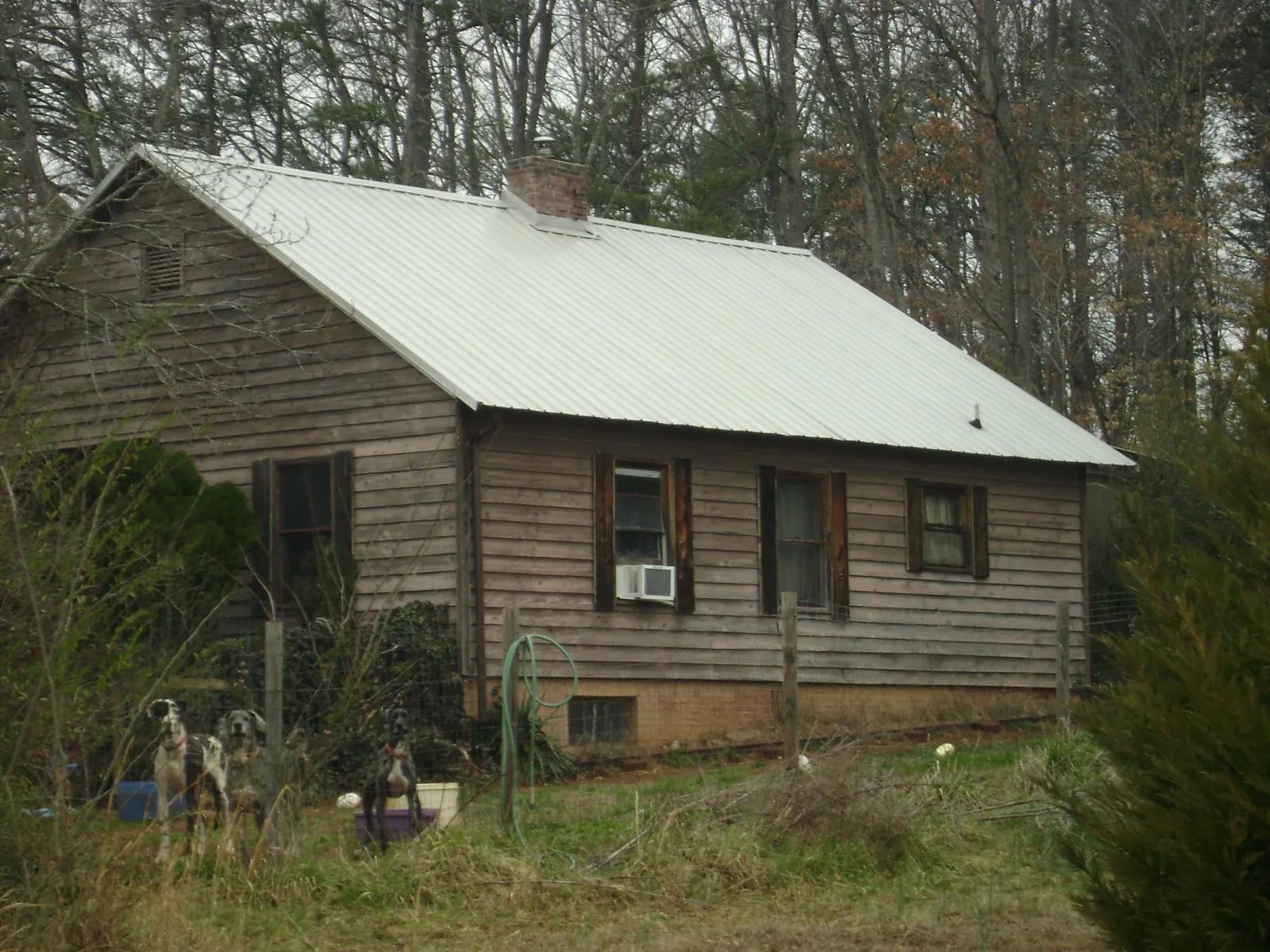 White metal roof on an old wood sided farmhouse, from a Metal Roof Installation job in Mount Hamilton